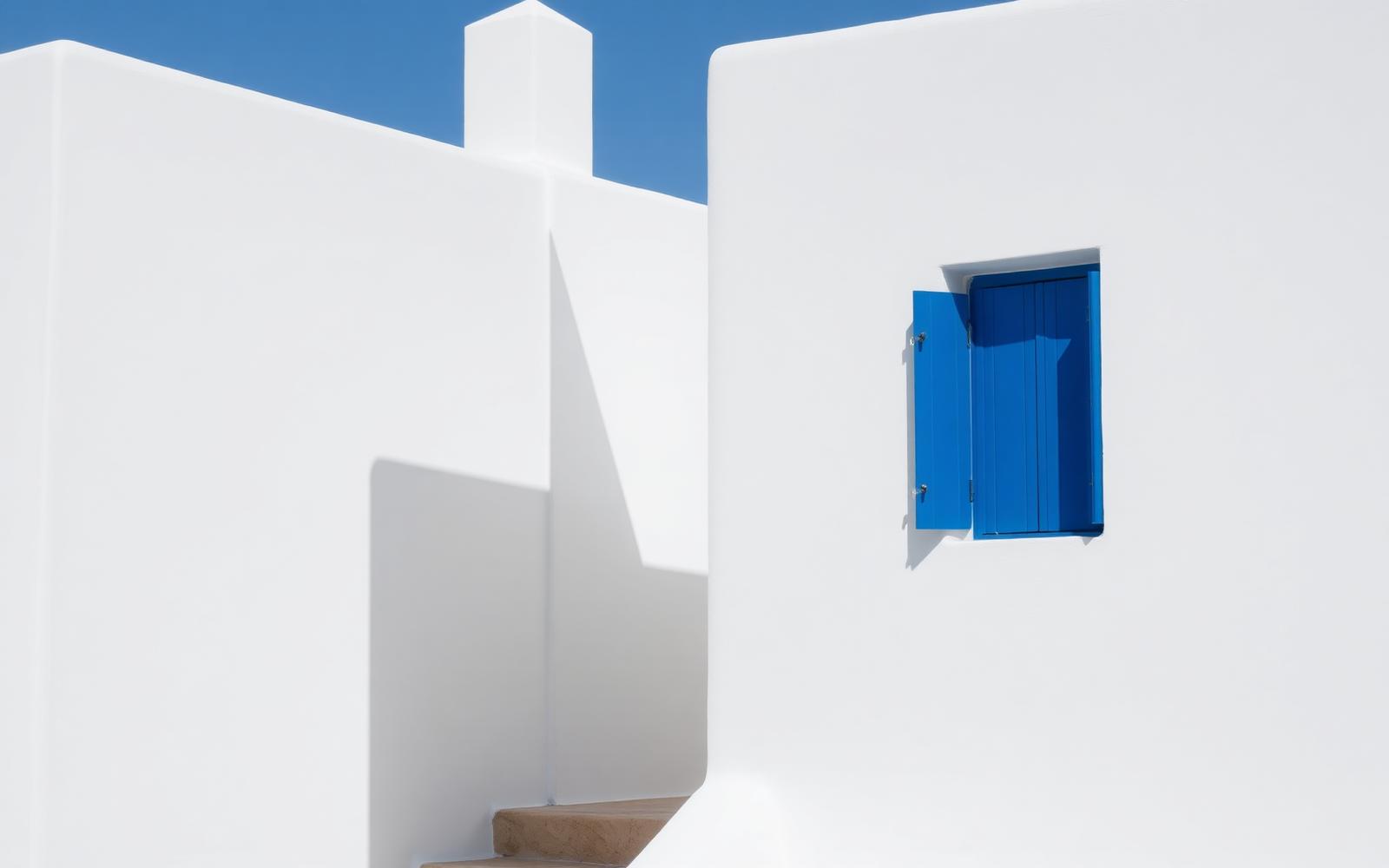 White Cycladic architecture with blue shutter
